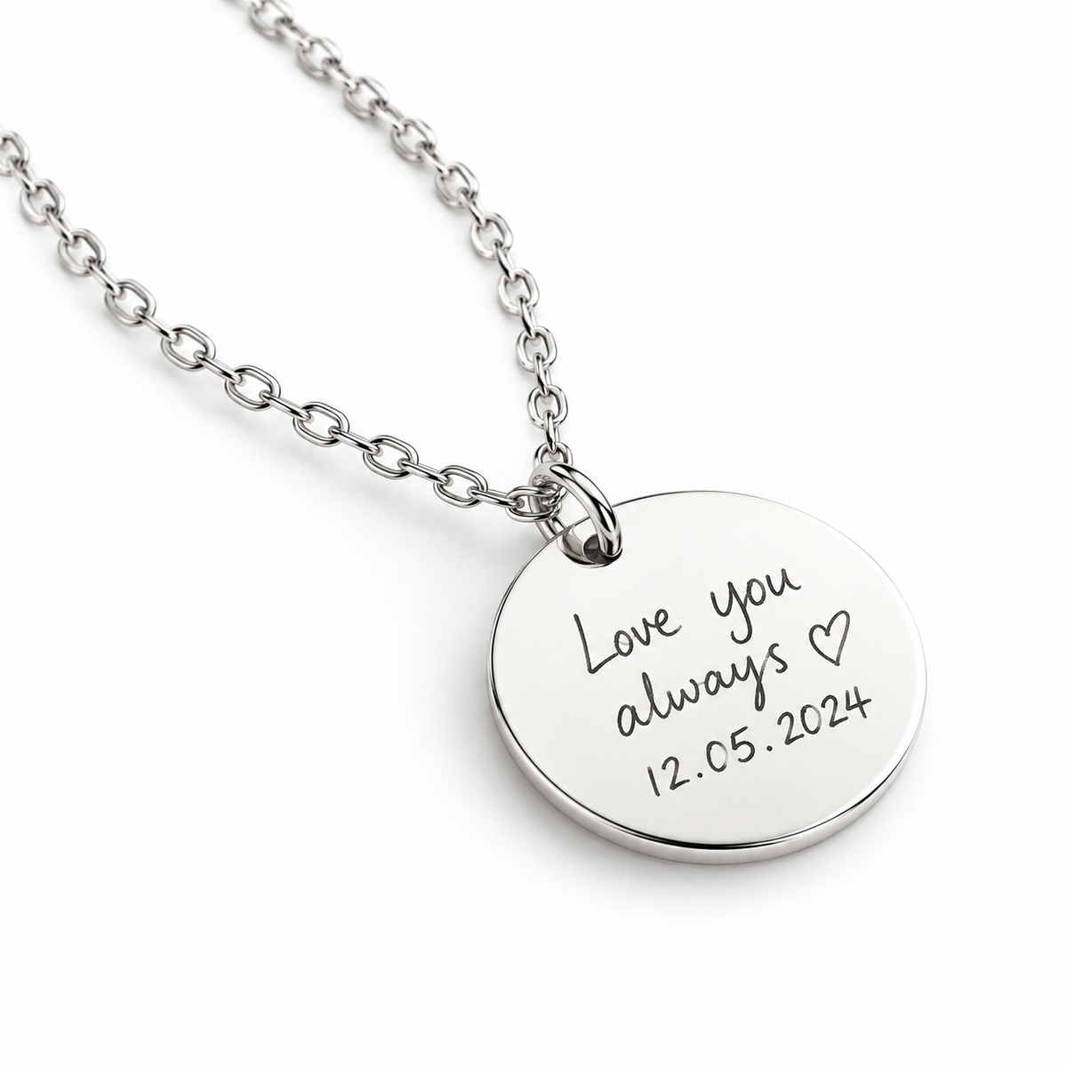 Silver disc pendant engraved with a handwritten message