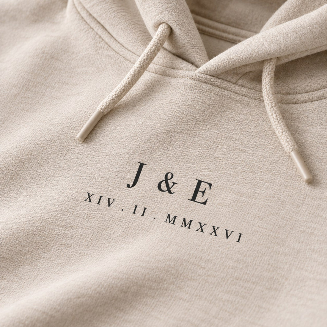 Close-up of custom initials and Roman numeral date print on a hoodie