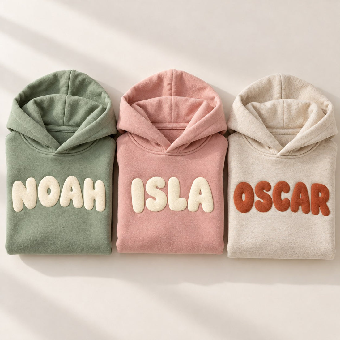 Personalised kids hoodies in three colours with bold name prints
