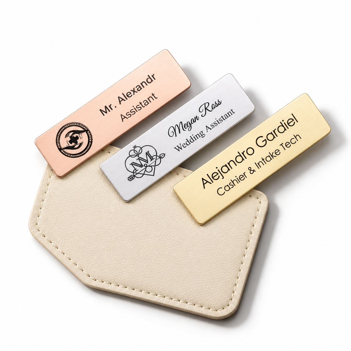 Personalised engraved name badges in rose gold, silver and gold on a cream leather holder