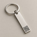 Personalised QR code bar keychain on a greige surface