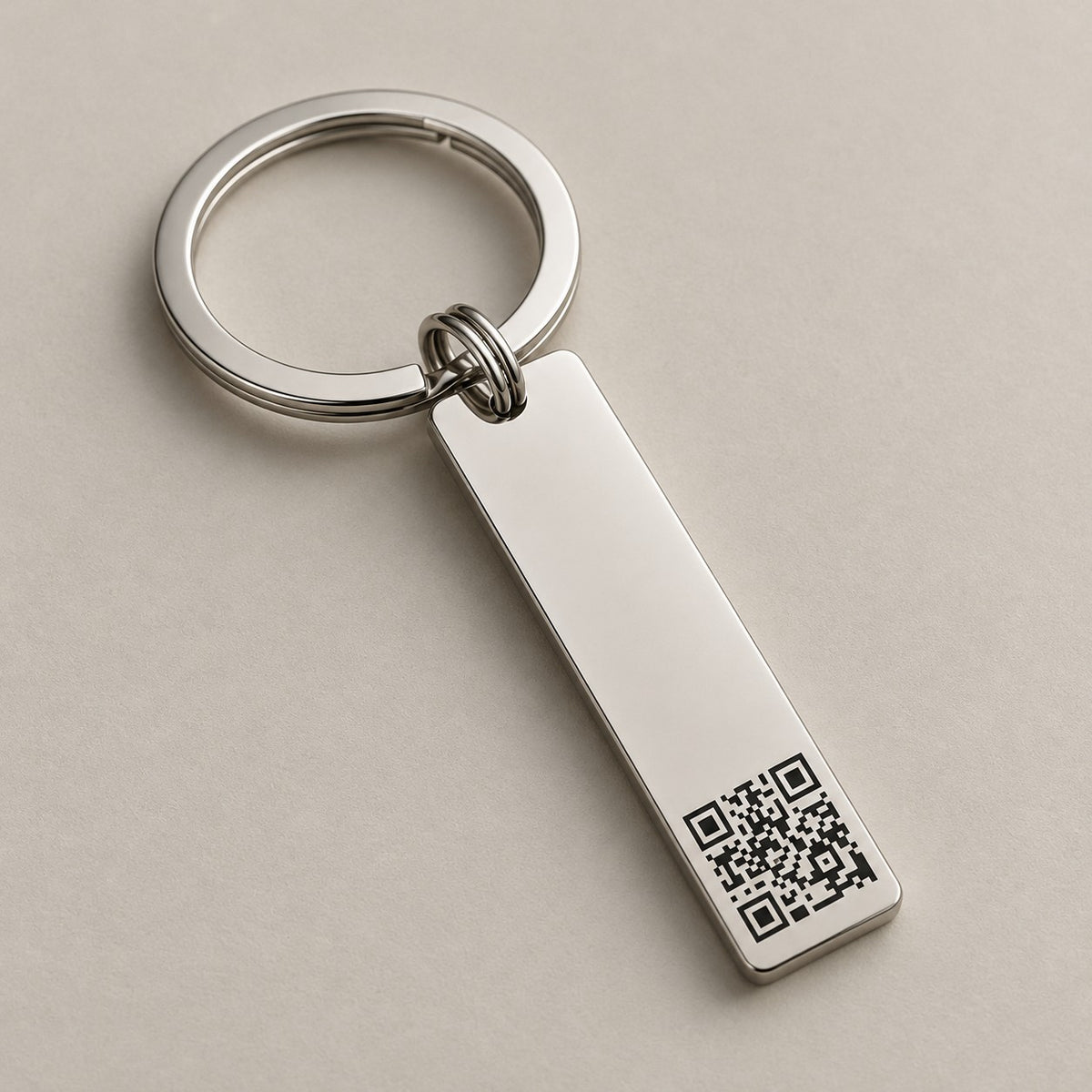 Personalised QR code bar keychain on a greige surface