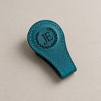 Personalised leather magnetic bookmark on a greige surface