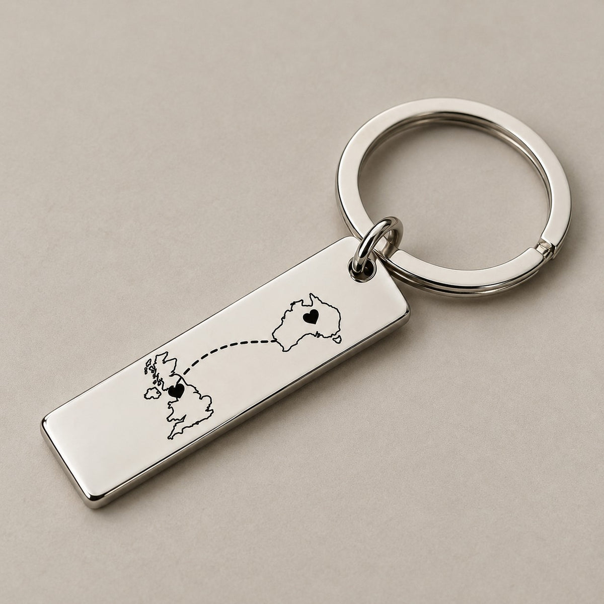 Customised country keychain on a greige surface