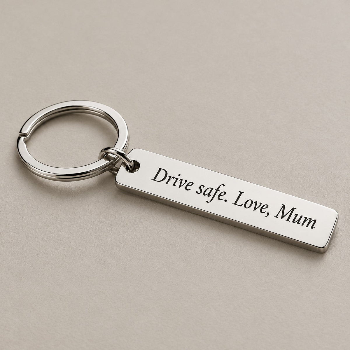Customised engraved keychain on a greige surface