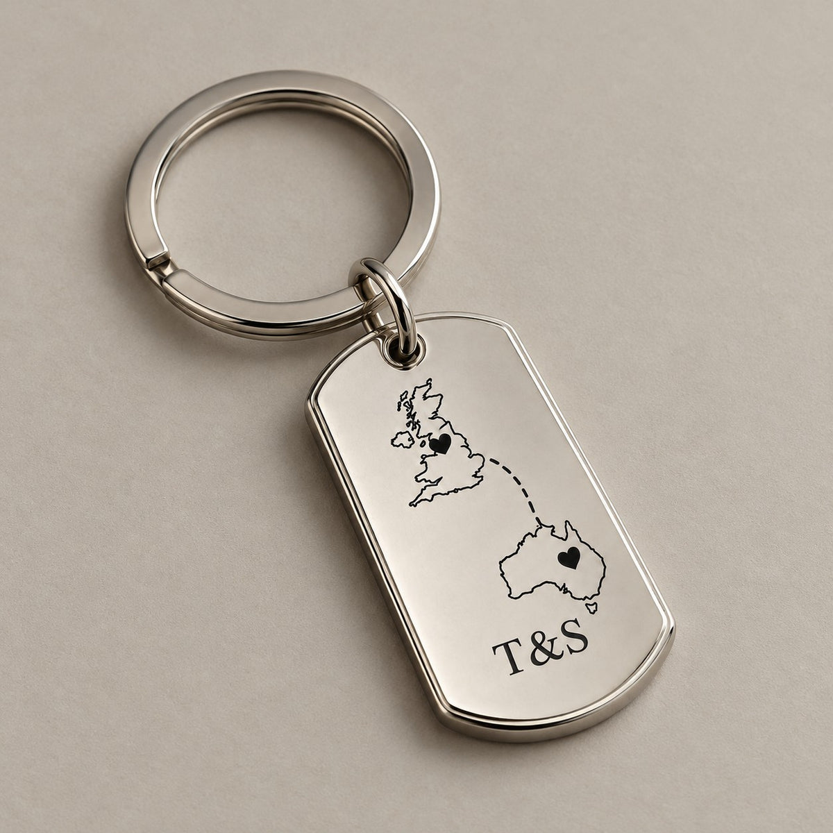 Customised country keychain on a greige surface