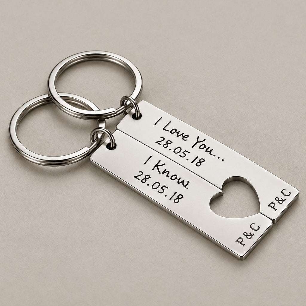 Personalised couples keychain pair on a greige surface
