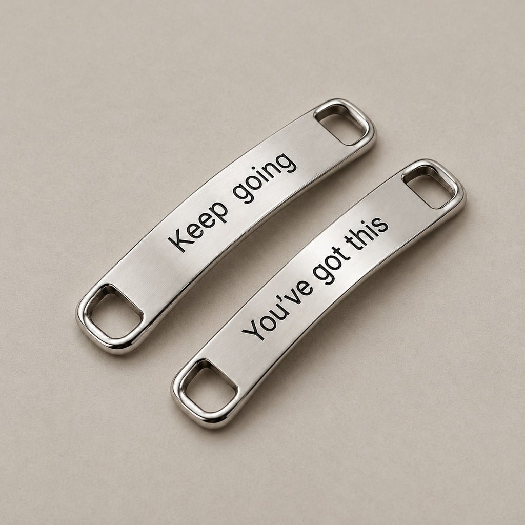 Custom engraved shoe tags on a greige surface