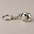 Personalised helmet keychain on a greige surface