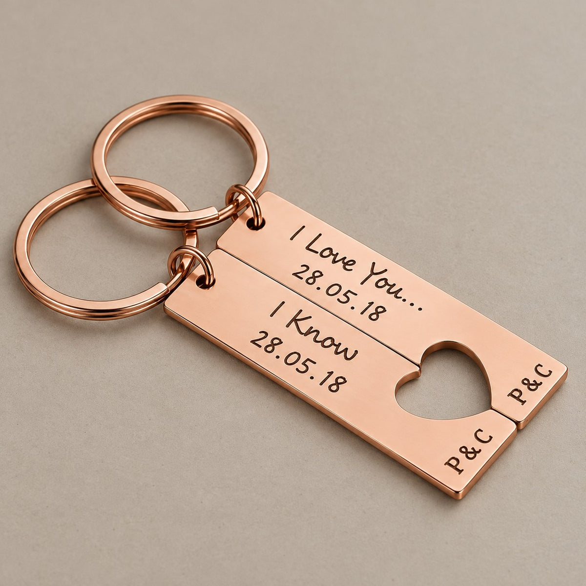 Engraved heart keychain set on a greige surface