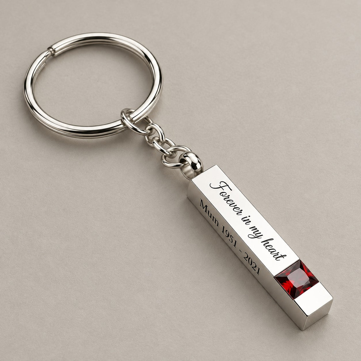 Personalised birthstone bar keychain on a greige surface