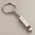Personalised birthstone bar keychain on a greige surface