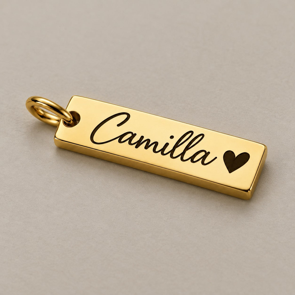 Personalised engraved name tag on a greige surface