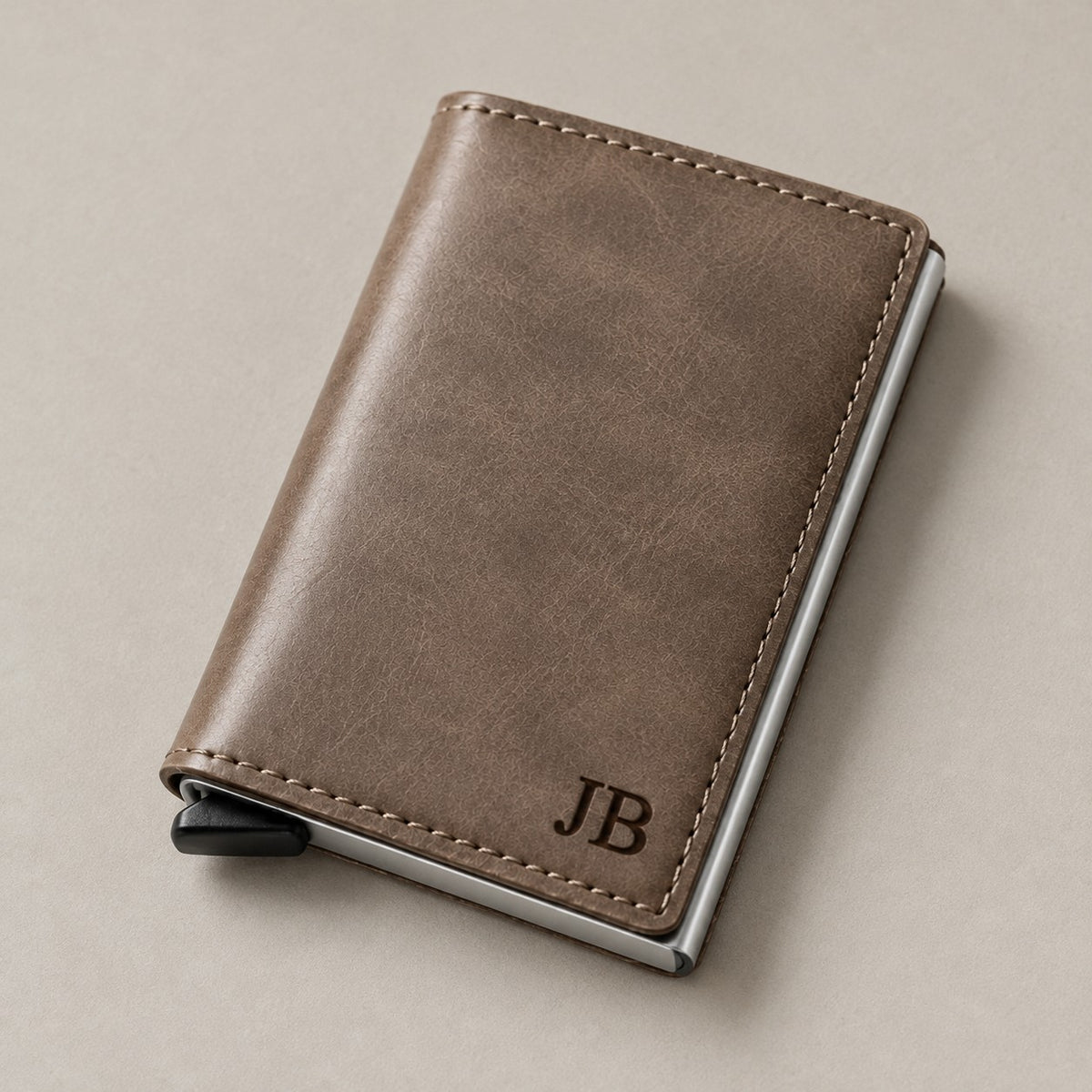 Personalised leather pop-up wallet on a greige surface