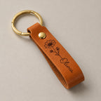 Birth flower leather keyring on a greige surface