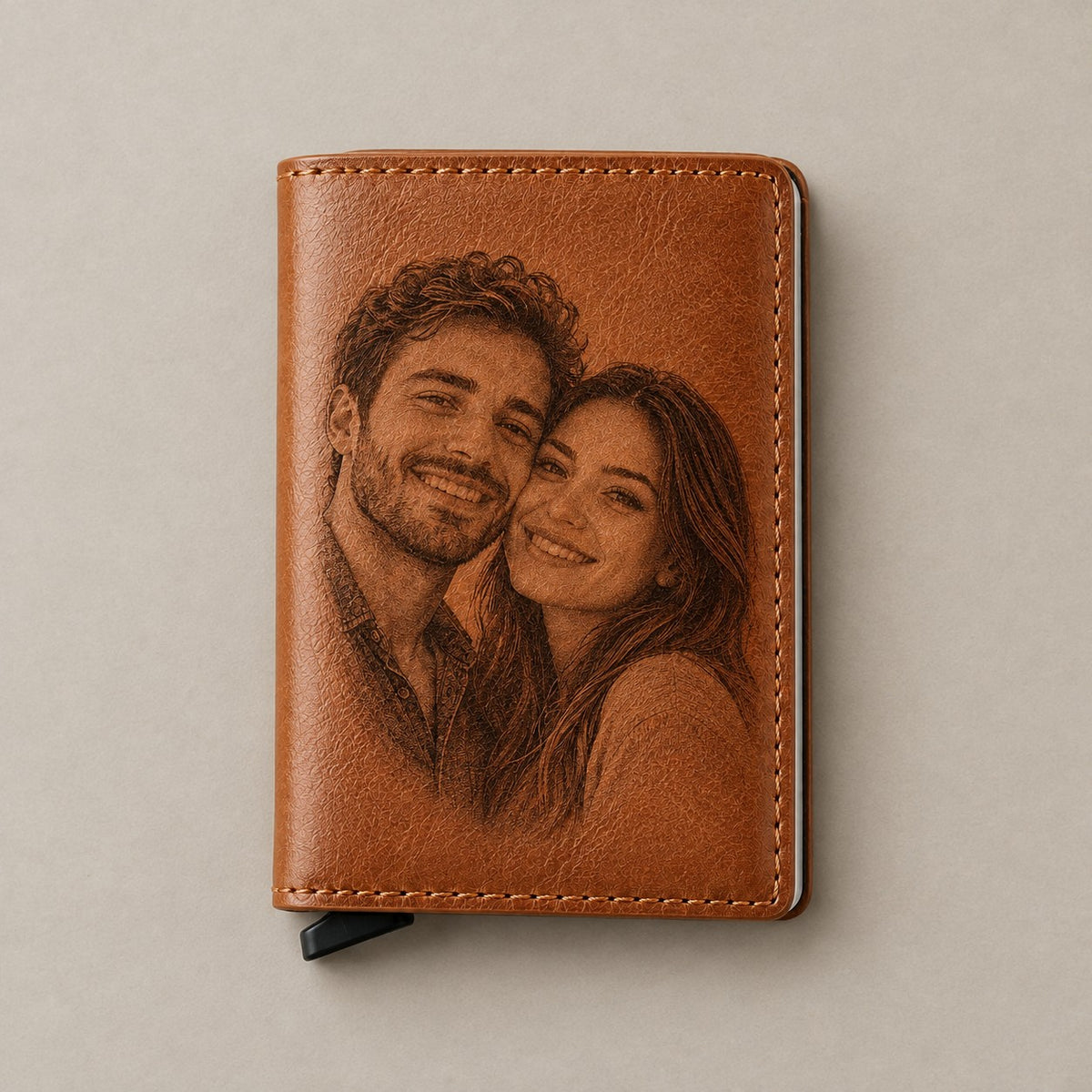 Photo engraved leather pop-up wallet on a greige surface