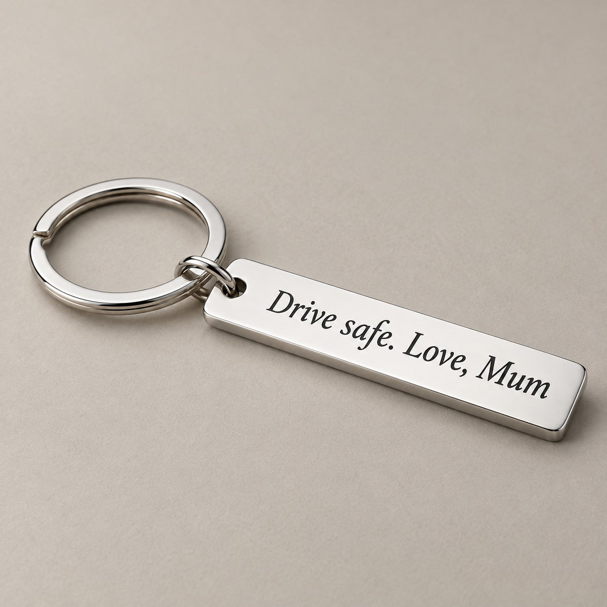 Customised engraved keychain on a greige surface