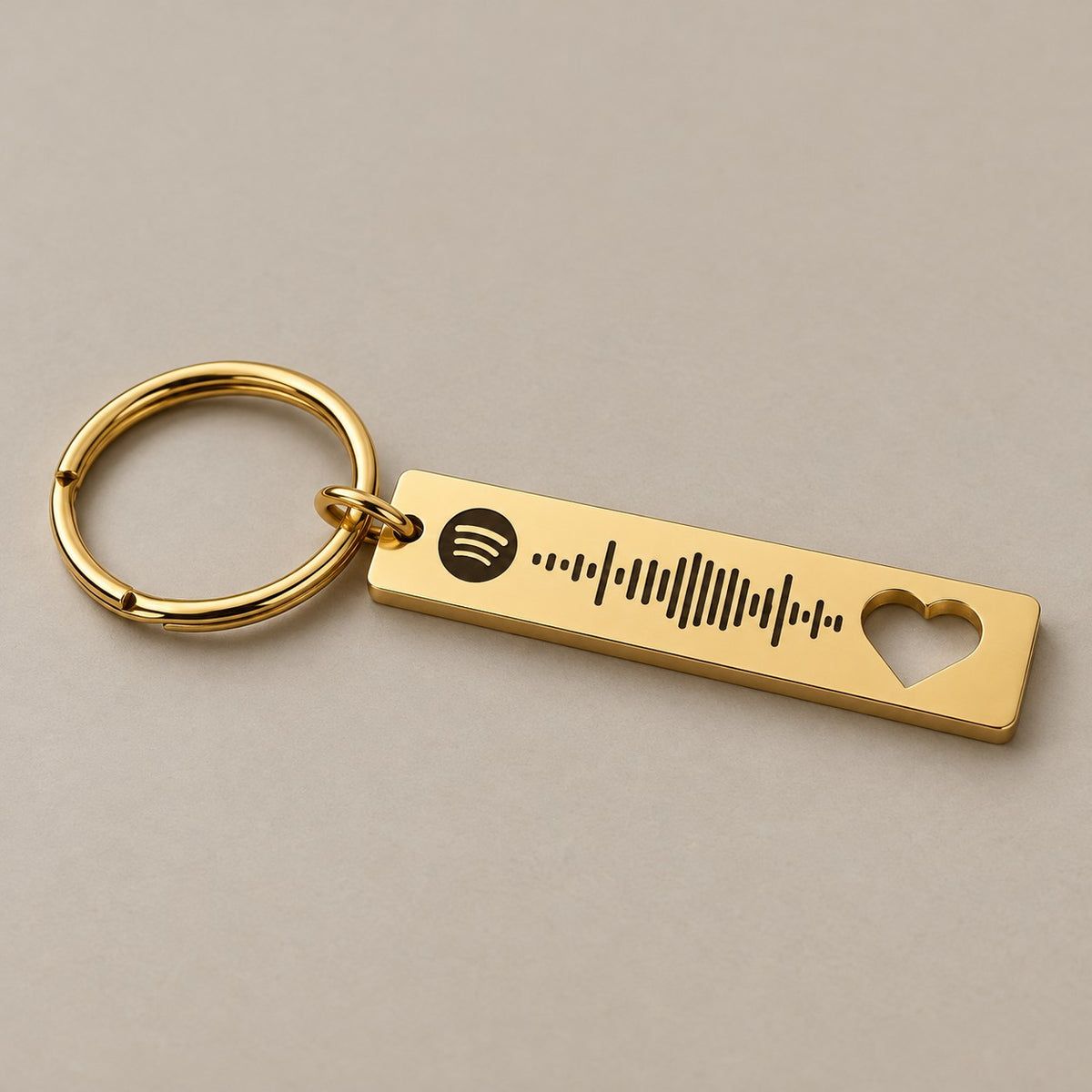 Gold Spotify scannable keyring on a neutral surface