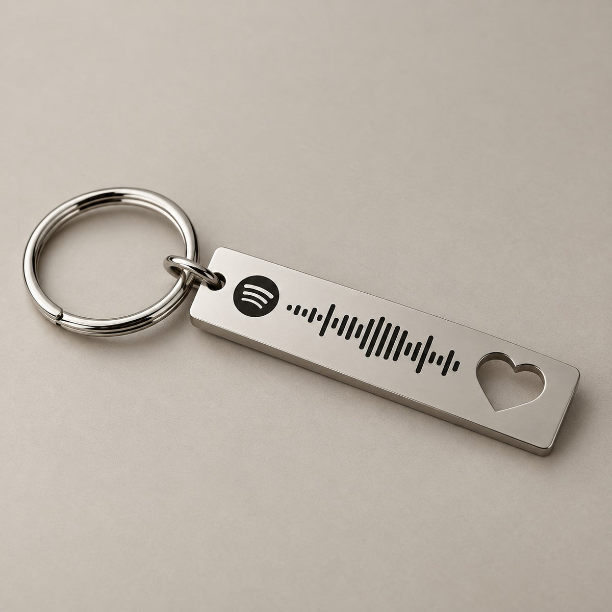 Heart-cut Spotify keyring on a neutral surface