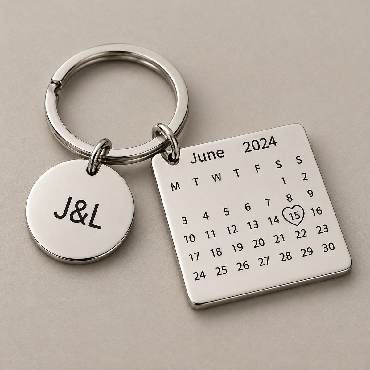 Personalised calendar keychain on a greige surface