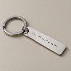 Personalised morse code keychain on a greige surface