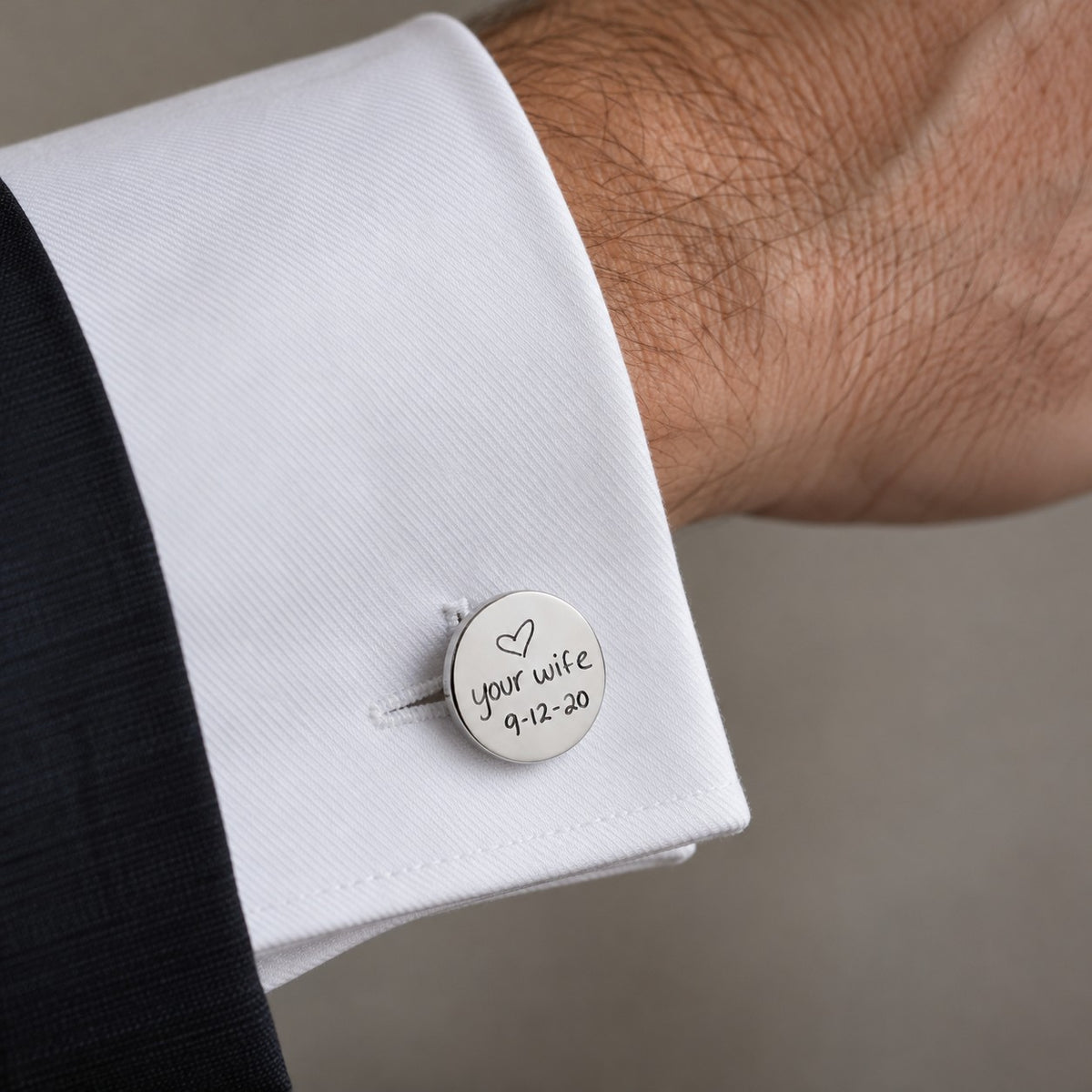 Personalised cufflink on shirt cuff