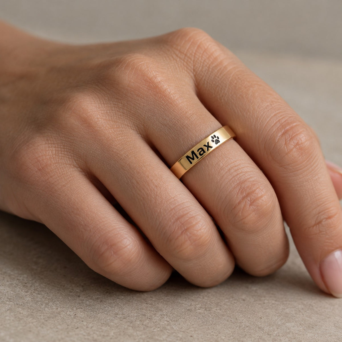 Personalised engraved ring worn on finger